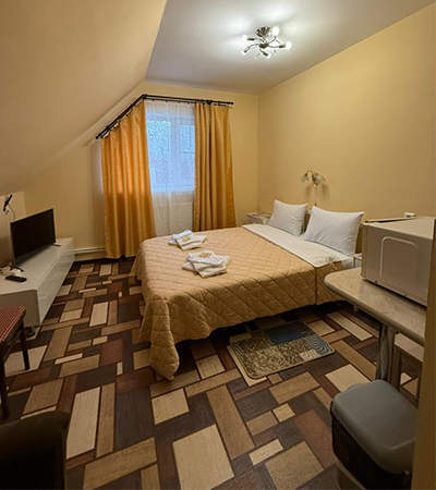 Семейный номер 35 м²  в отеле Турист, Луга - комната с большой кроватью